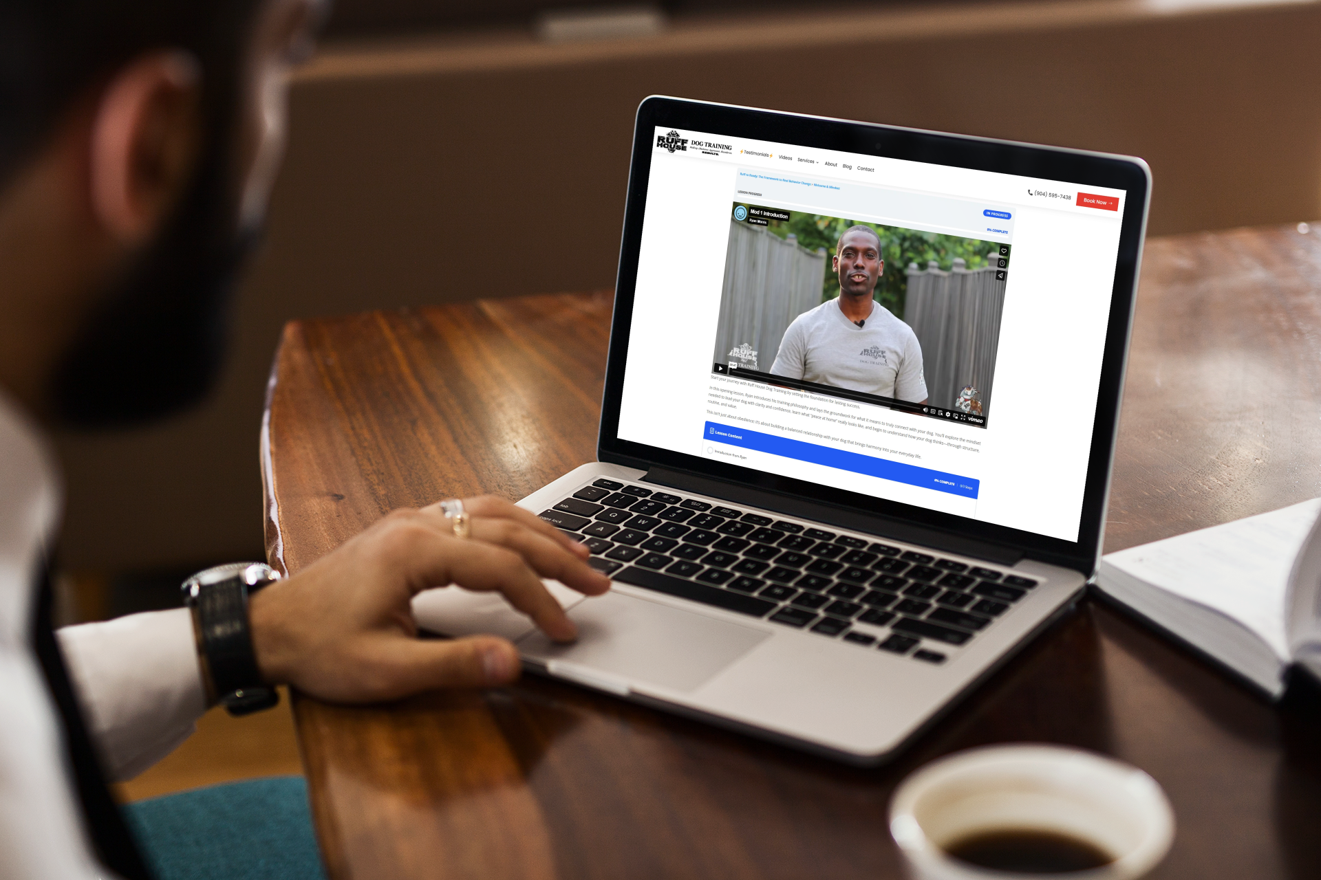 mockup featuring a man using his macbook pro on a wooden desk 2321 el1